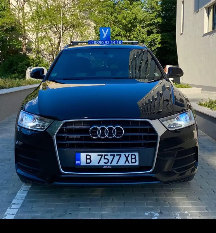 Черен учебен Audi SUV с табела У, заснет отпред